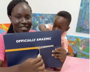 Mother of Ace-Liam, the World's youngest male artist, unboxing the certificate