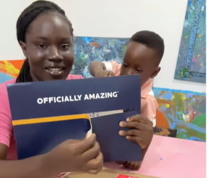 Mother of Ace-Liam, the World's youngest male artist, unboxing the certificate