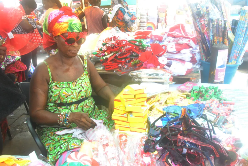 Madam Cecelia Naa Kwalley Owoo sells balloons and fire crackers Photos Okai Elizabeth